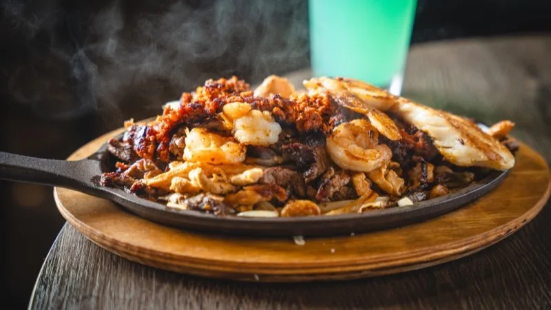 El Molcajete sizzling fajitas mar y tierra
